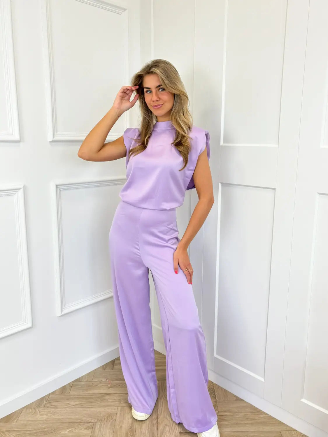 A lavender satin backless evening dress jumpsuit with a high neckline and wide-leg straight pants.