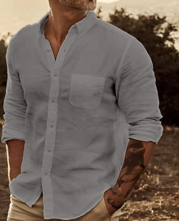 Men’s slim fit cotton long sleeve button down shirt in light blue with a chest pocket and rolled-up sleeves.