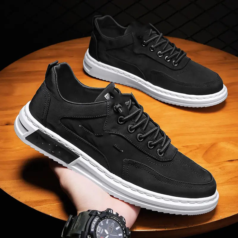 Black suede canvas sneakers with white rubber soles and a modern chunky design ideal for casual sports use.