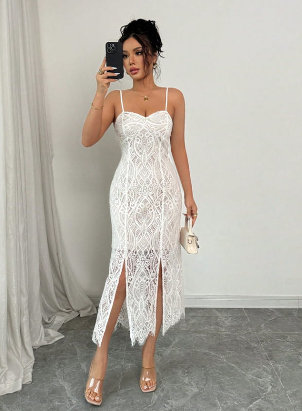 A white floral lace v neck midi dress with thin spaghetti straps and a high slit along the left leg.