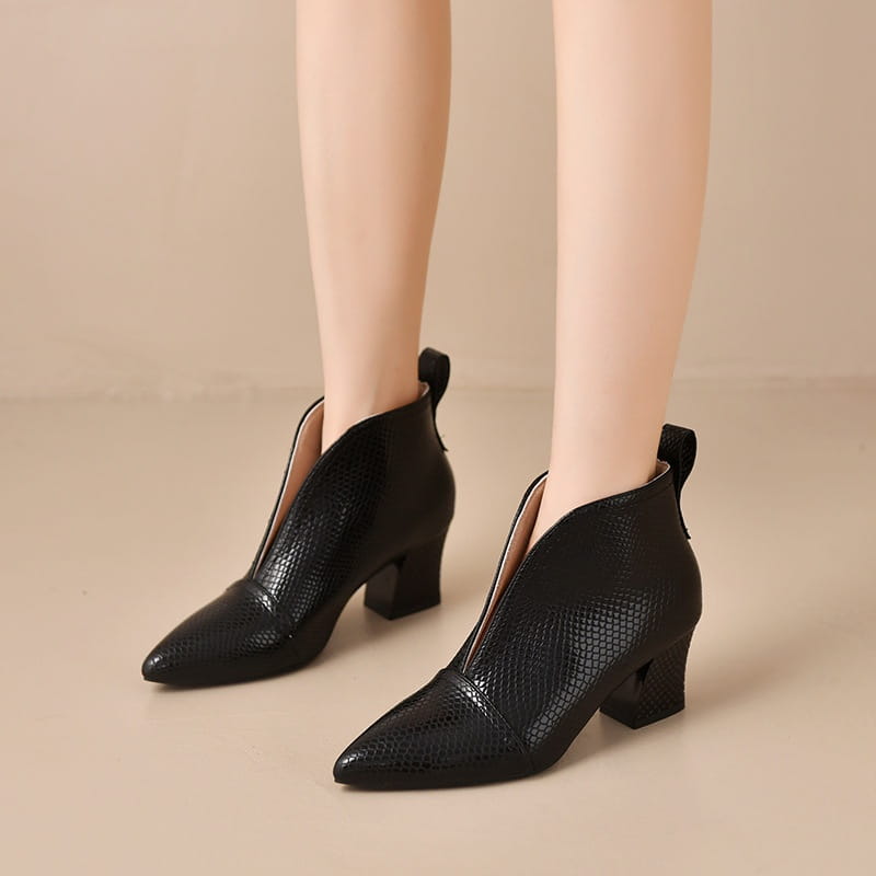 Black snakeskin ankle boots with v cut pointed toe, block heel, and zipper closure.