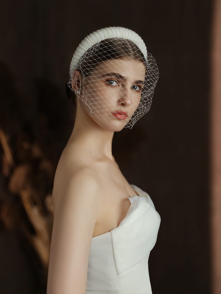 White beaded veil headpiece with delicate mesh netting designed as a vintage French Hepburn beaded bridal veil headband.