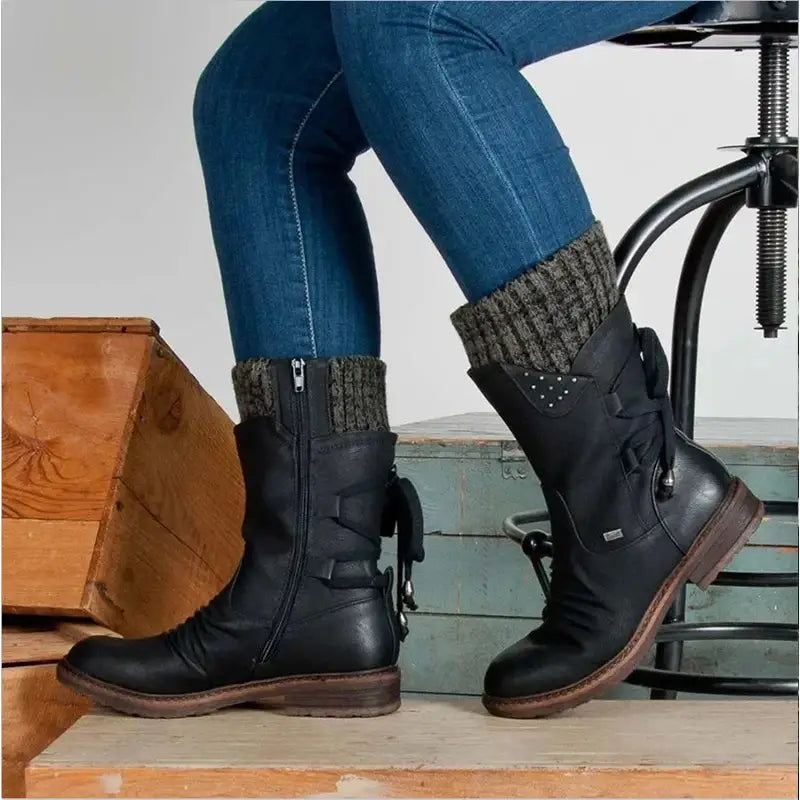 Black leather women winter snow boots with a textured knit cuff and decorative studs made of suede mid calf martin shoes.