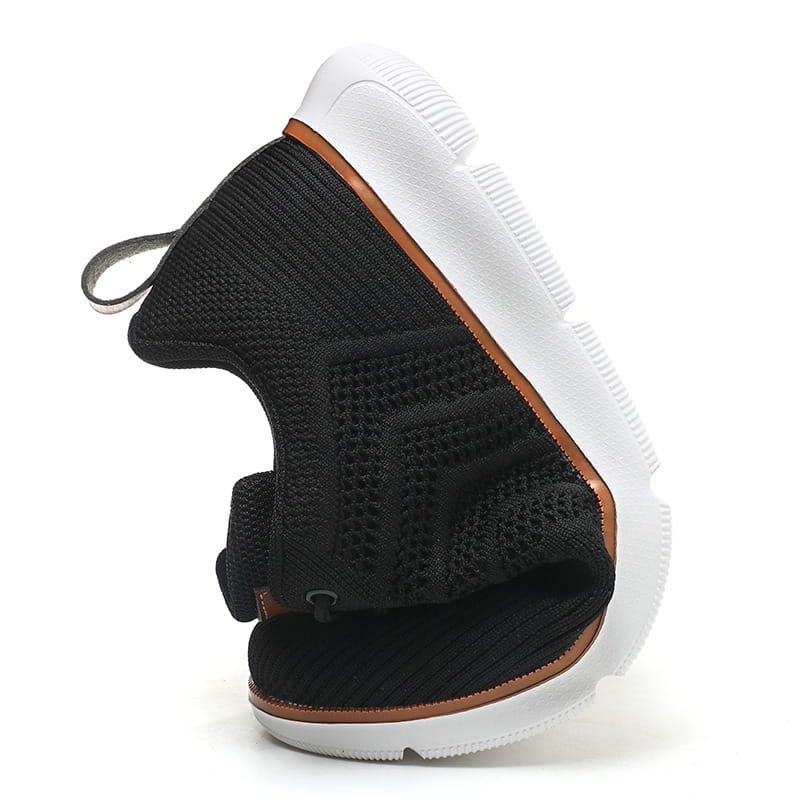 Black knit mesh sneaker for men with white rubber sole and tan accent trim designed for casual flying woven shoes.