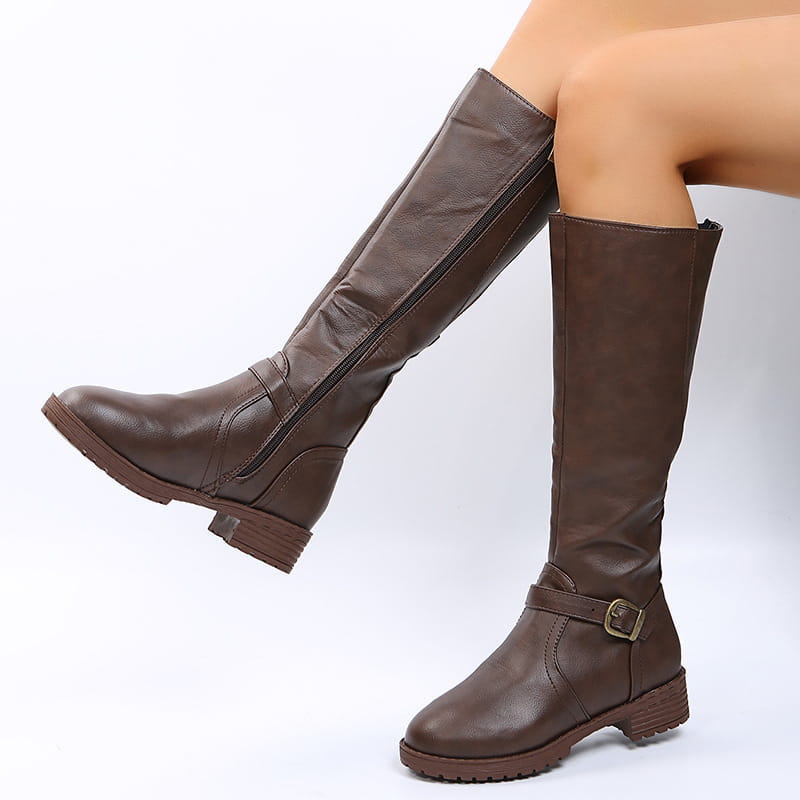 Brown leather knee high knight boots with a buckle strap and low block heel shown from the back side.