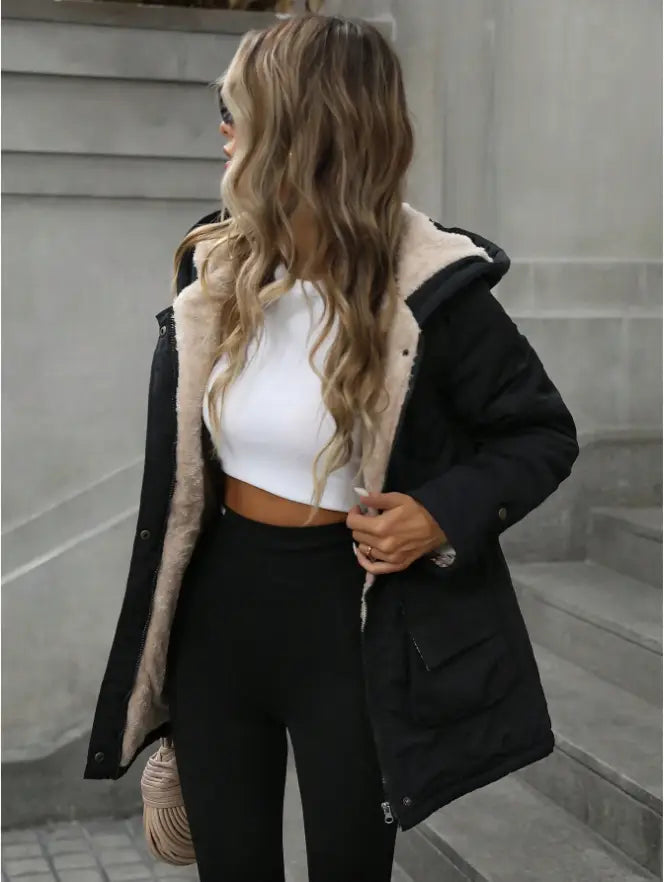 Black shearling lined hooded zip up parka featuring a cozy plush interior and classic buttoned front design.
