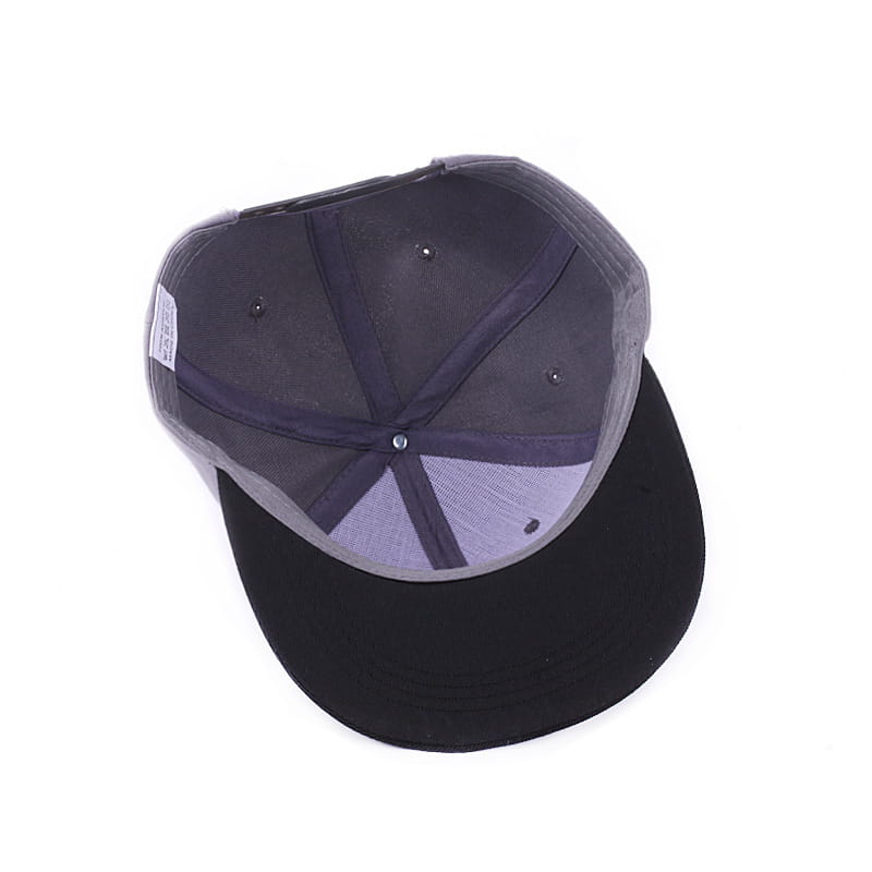 Black and gray snapback baseball cap with flat brim featuring skeleton hand embroidery on the front.