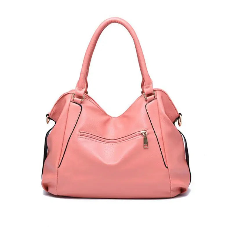 A soft pink structured women totes bag made of pu leather featuring curved top handles and a front zippered pocket for high capacity shoulder use.