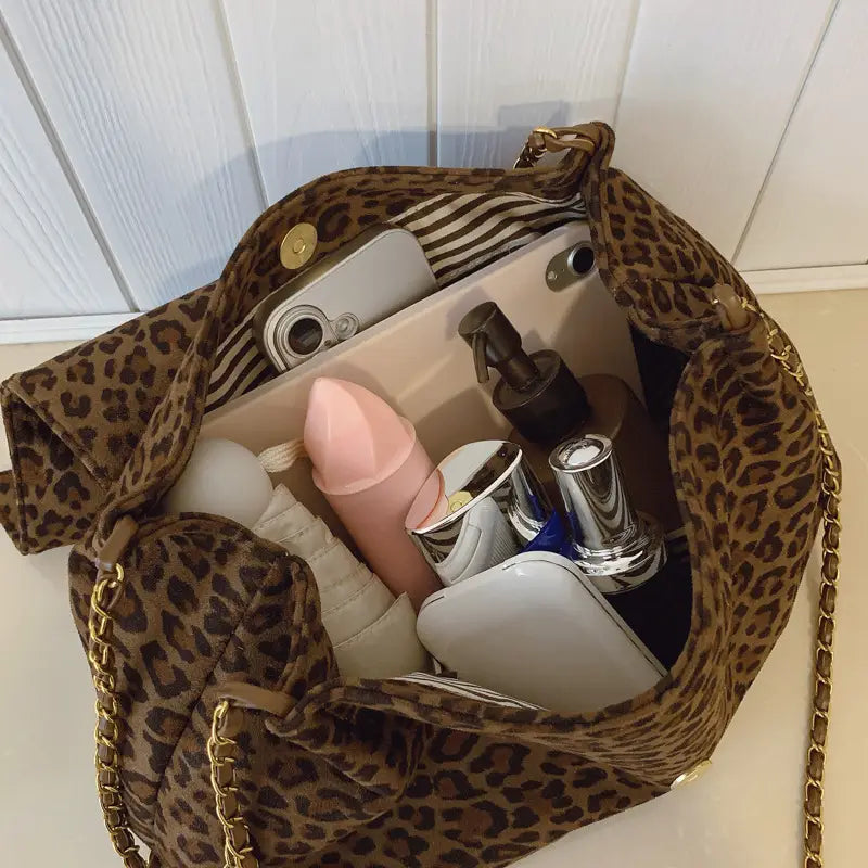 Leopard print crossbody bag made of velvet with a gold-tone chain strap and hardware.