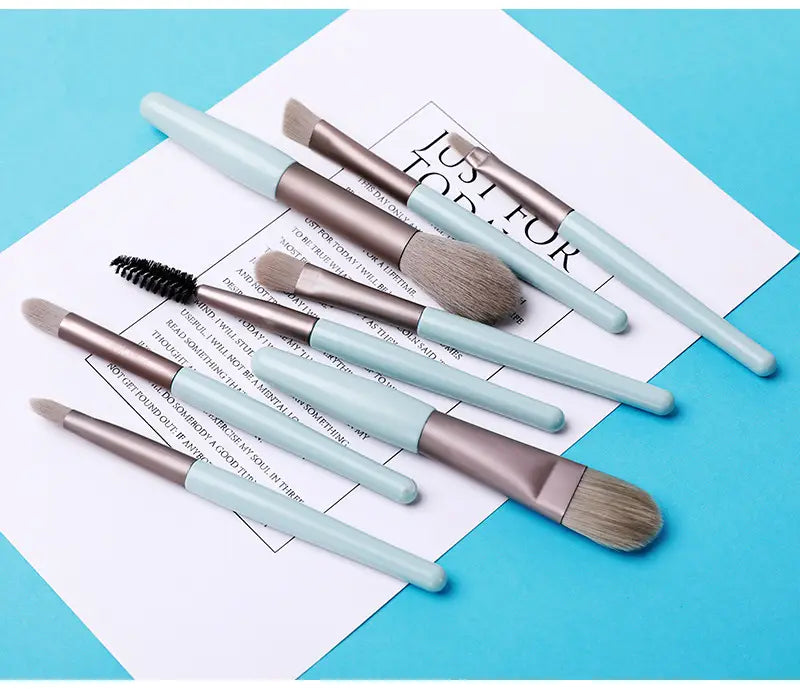 Set of seven light blue and metallic silver makeup brushes with soft bristles included in a makeup brush set with 8 pieces and leather case.