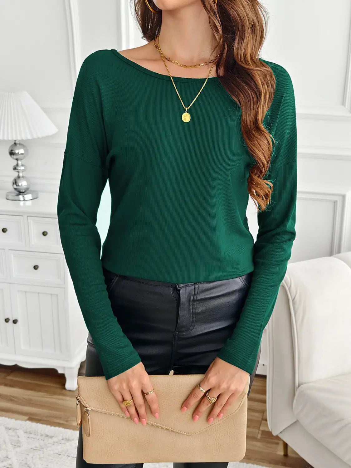 Emerald green ribbed long sleeve top with a boat neckline and butterfly lace back detailing.