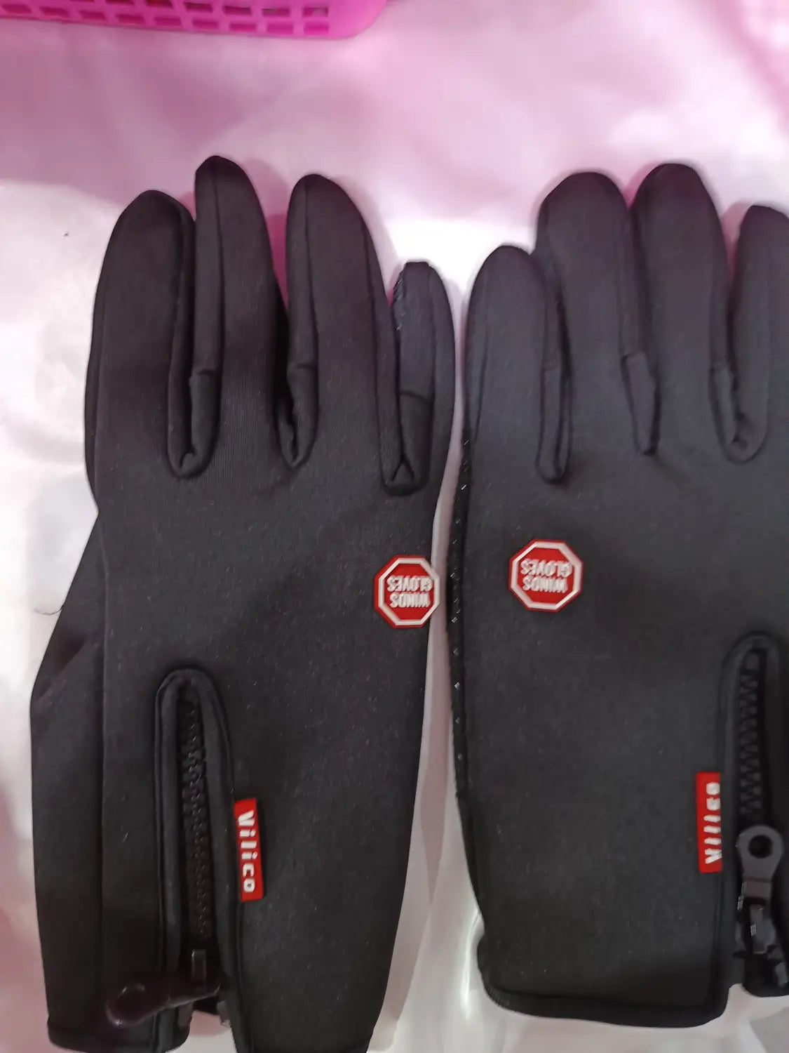 black touchscreen winter gloves with red branding and zipper pockets shown from the back side designed for windproof use by men and women