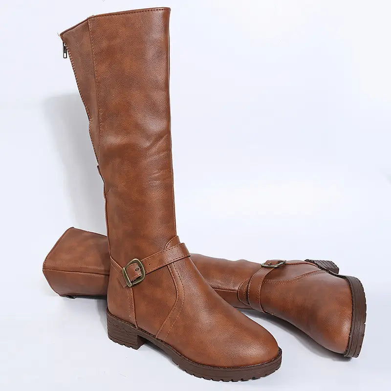 brown faux leather knee high knight boots featuring a buckle strap and low block heel shown from the back side