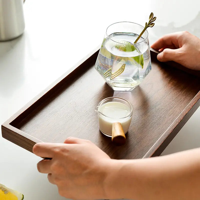 Dark brown acacia wood rectangular serving tray with a smooth polished surface and slightly raised edges.