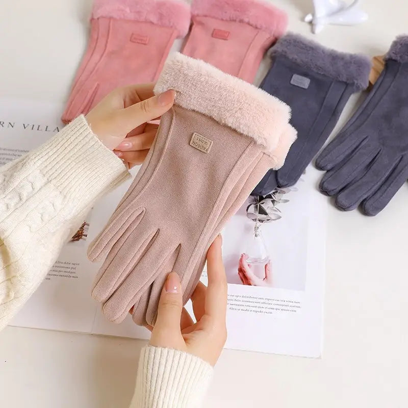 Beige suede women’s thermal touchscreen gloves with plush pink fleece cuffs and a small rectangular brand tag shown from the back.