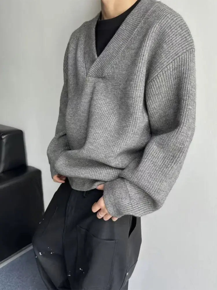 Gray ribbed knit v-neck pullover sweater with a relaxed oversized fit made of soft material for casual wear.