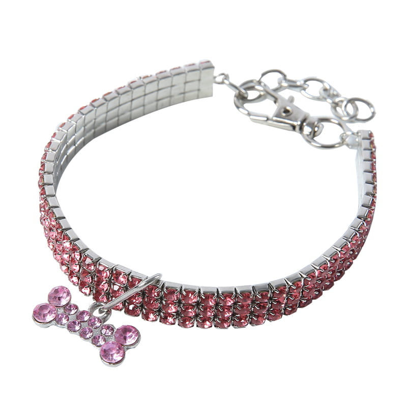 Pink rhinestone dog collar with a silver-tone metal clasp and crystal bone-shaped charm for stylish pet accessory.
