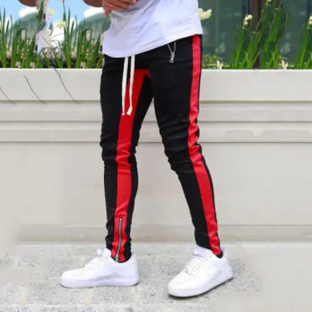 Men’s athletic black joggers with bold red side stripes white drawstring waistband and zipper cuffs designed for sports and casual wear.