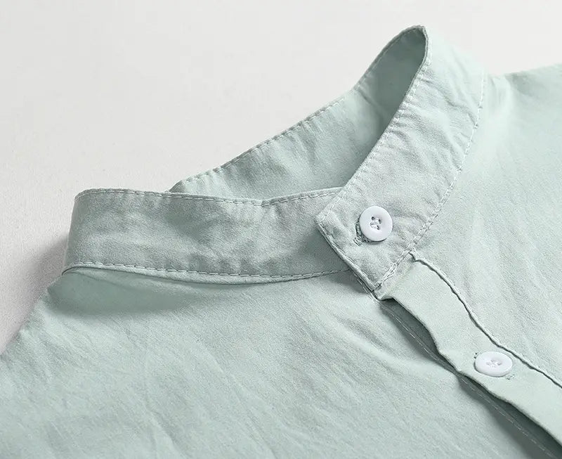 Men’s casual short sleeve linen blend summer shirt in light green cotton with a crisp collar and white buttons.