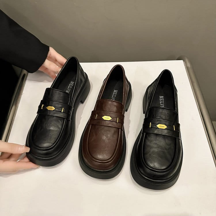 Brown leather loafers with gold-tone hexagonal buckles on a thick chunky sole in black and brown leather.