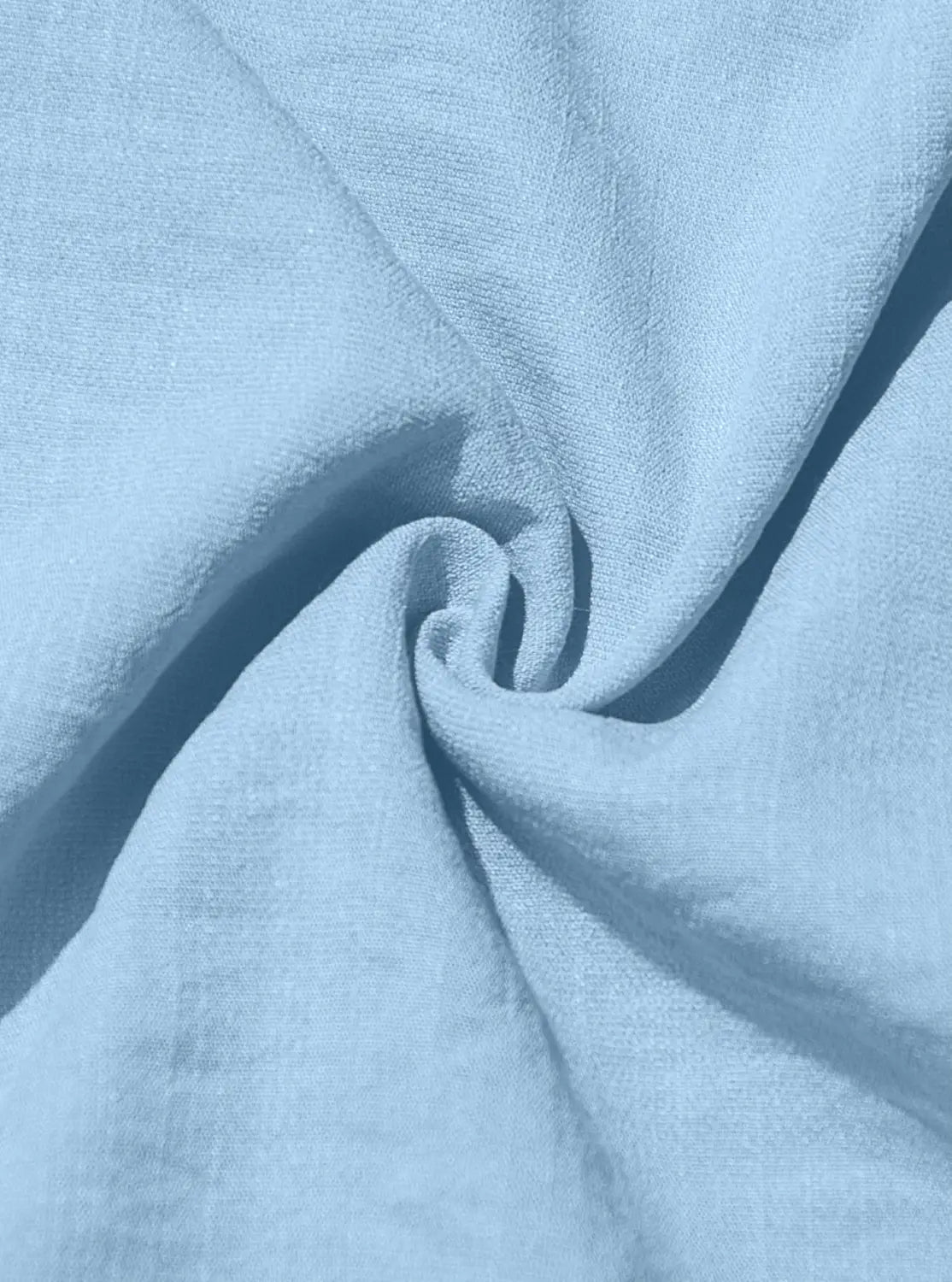 Light blue men’s textured bamboo linen short sleeve button down shirt fabric with gentle folds and subtle weave pattern.