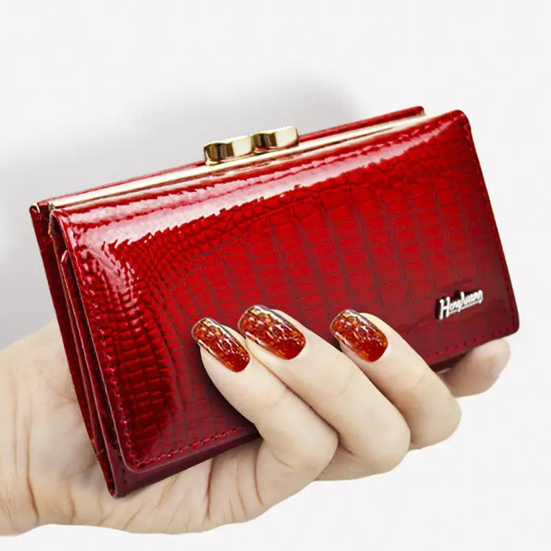 A glossy red retro crocodile pattern leather trifold wallet with a gold-toned clasp featuring the brand name hengyuan on its side.