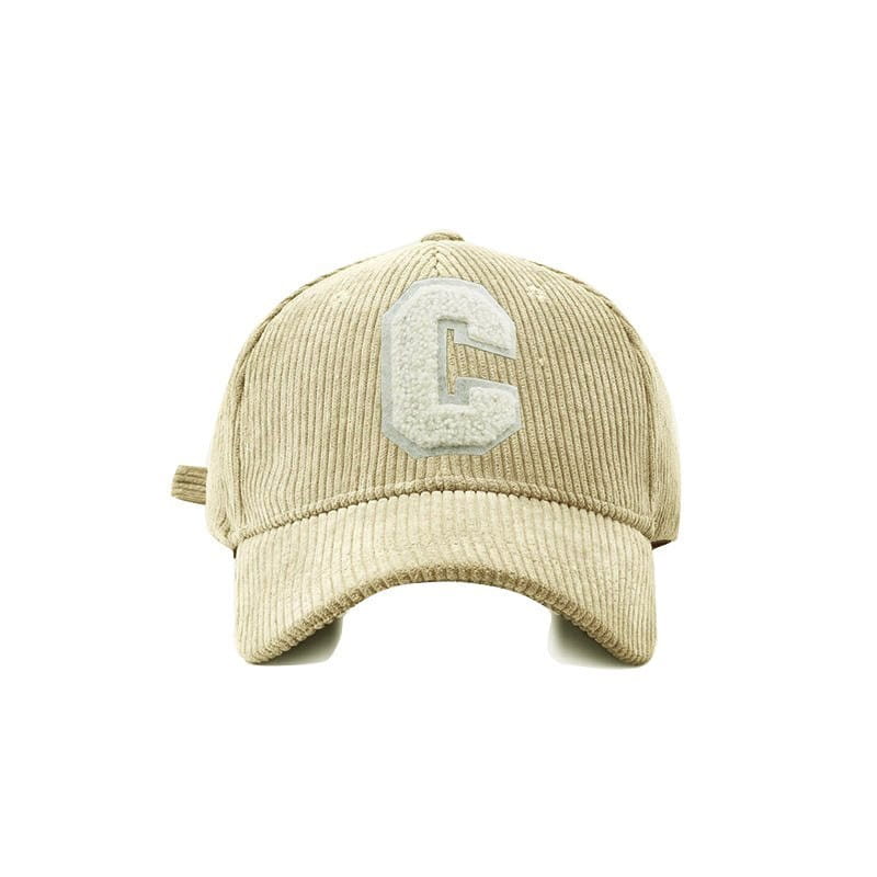 Beige corduroy baseball cap with a textured white embroidered letter c on the front.