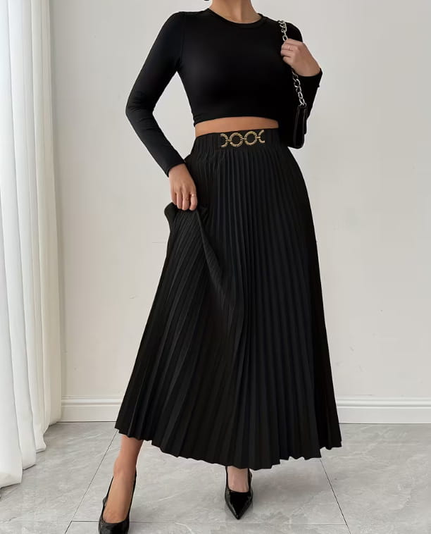 Black pleated midi skirt with high-waisted a-line design and metallic belt buckle featuring three interlocking circular details.