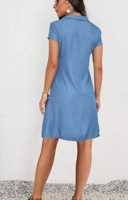 A light blue plus size short sleeve button front denim dress made of tencel with a collar.