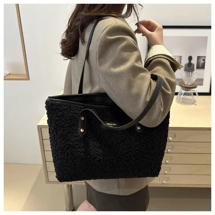 brown faux fur tote bag featuring black fuzzy texture with black leather straps and metallic hardware accents
