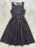 Celestial print 1950s black cotton midi dress with pockets featuring a vibrant stars moons and planets pattern