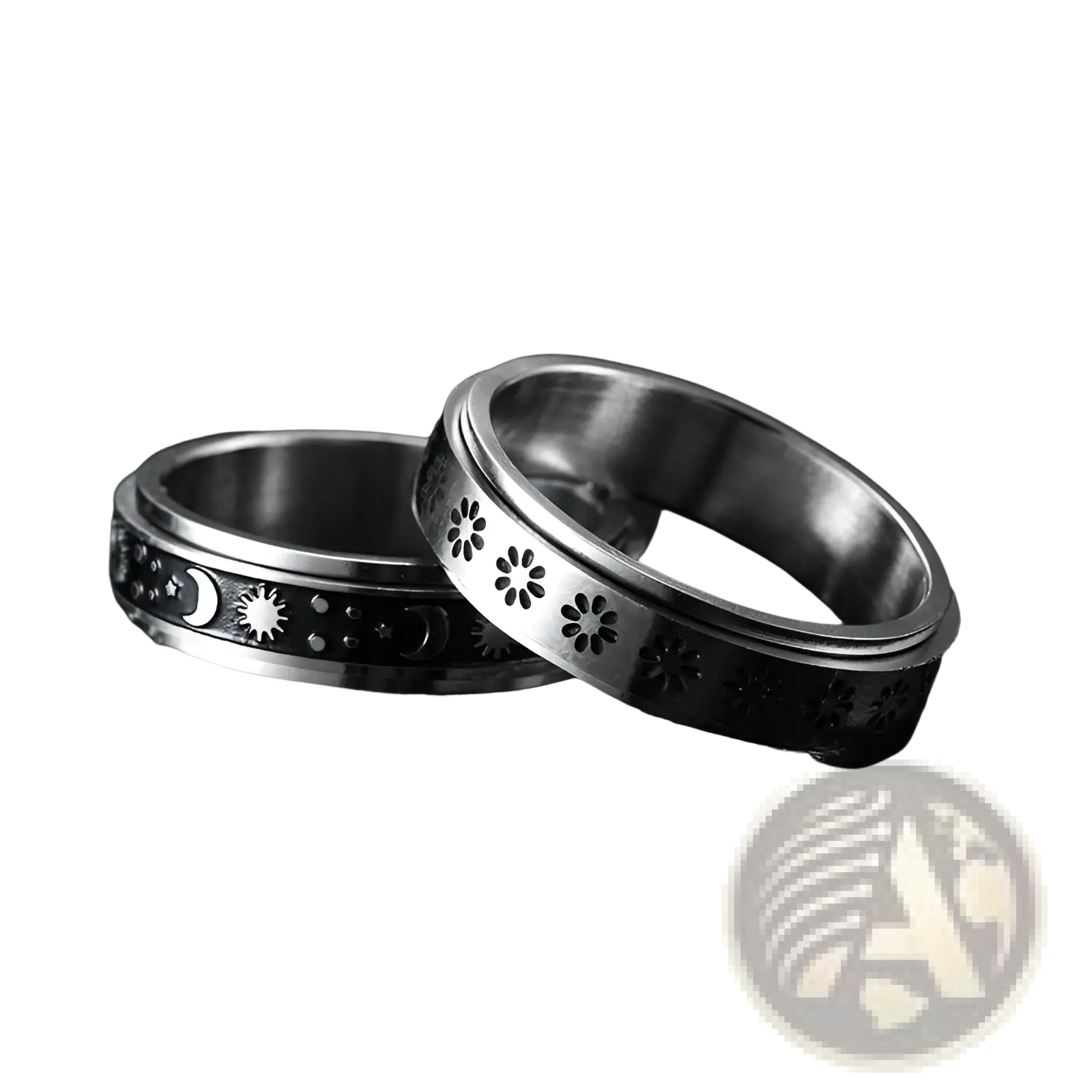 Two silver-toned stainless steel spinner rings with celestial moons stars and floral cutouts for anxiety relief