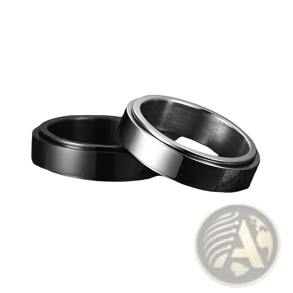 Two sleek celestial stainless steel anxiety spinner rings with polished silver and matte black inner band on black leather