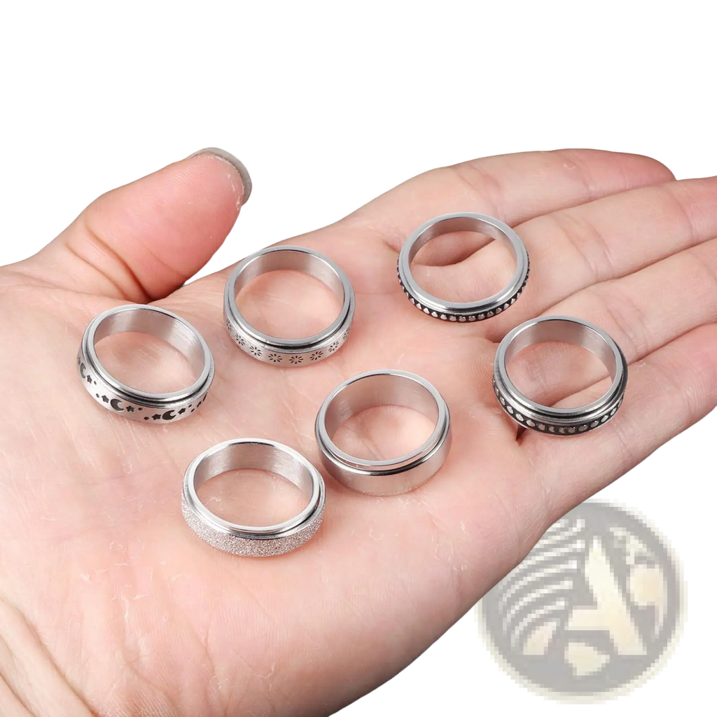Set of six silver-toned celestial stainless steel anxiety spinner rings with intricate designs and textured surfaces