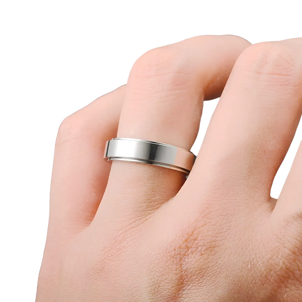 A sleek silver-toned stainless steel celestial anxiety spinner ring with modern polished and brushed two-tone design