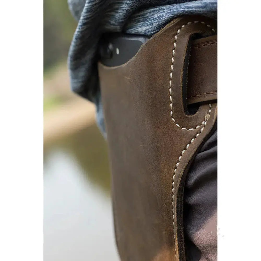 Brown pu leather phone holster with belt loop and card slots featuring contrasting white stitching and a black smartphone inside