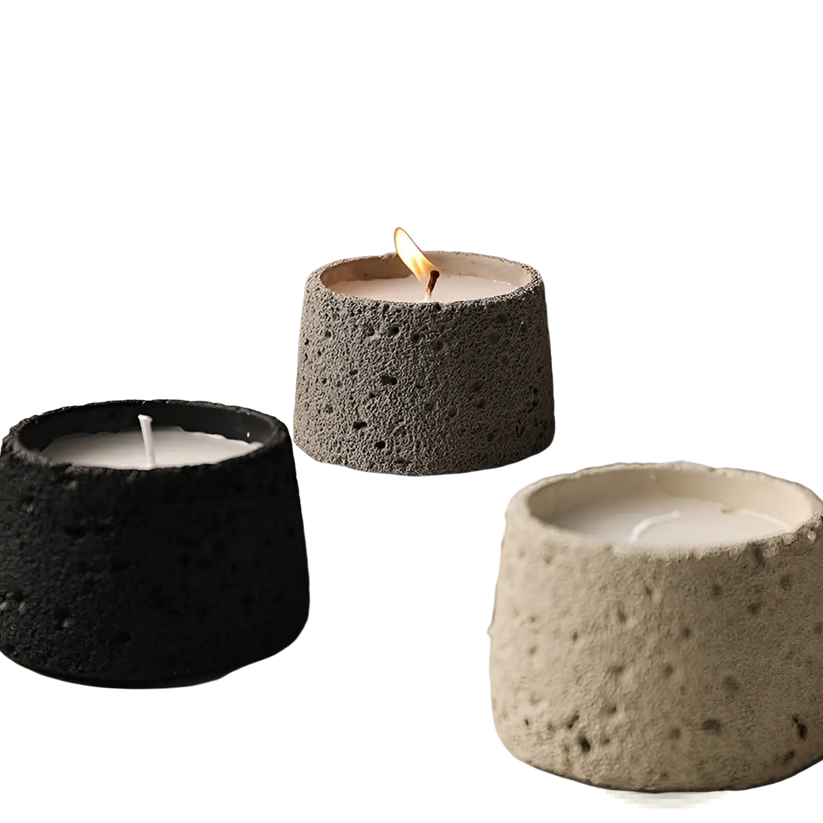 Three cylindrical cement candle holders in black gray and beige with speckled porous concrete surface for aromatherapy