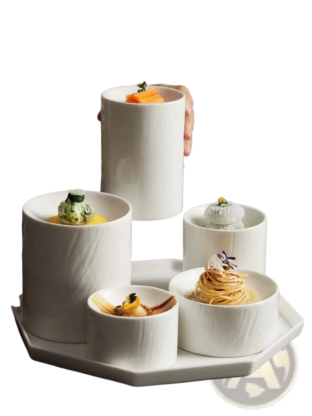 White ceramic cylindrical appetizer bowls with a matte textured finish arranged on an octagonal tray