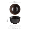 A dark brown ceramic bowl with speckled glaze and rounded flared rim for retro porcelain rice tableware use