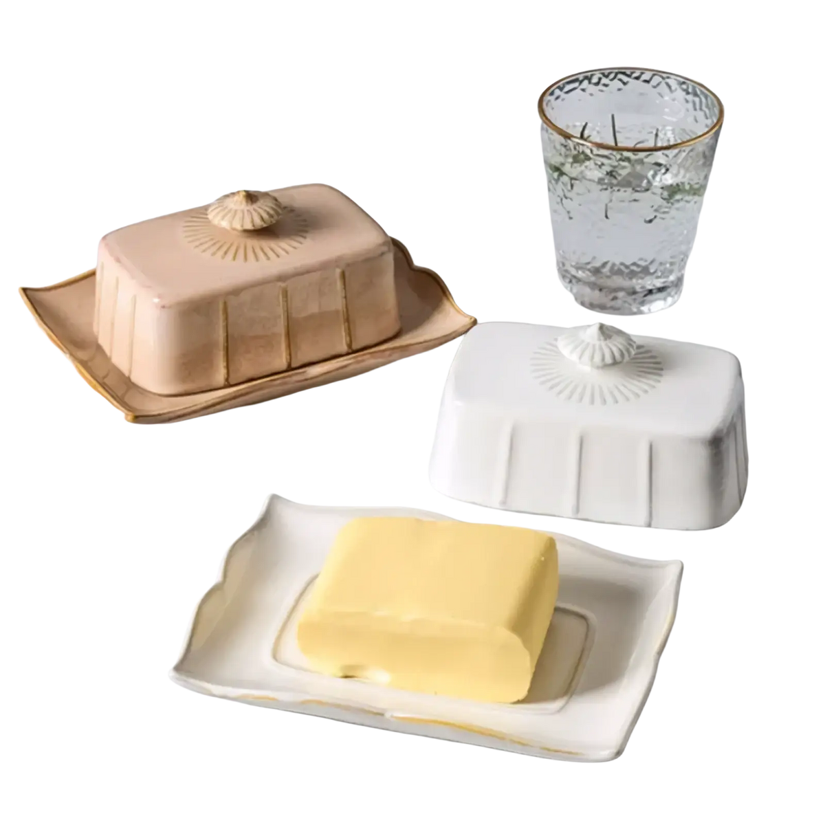 Beige ceramic butter dish with gold trim featuring a shell-shaped lid and vertical ridges on a matching tray