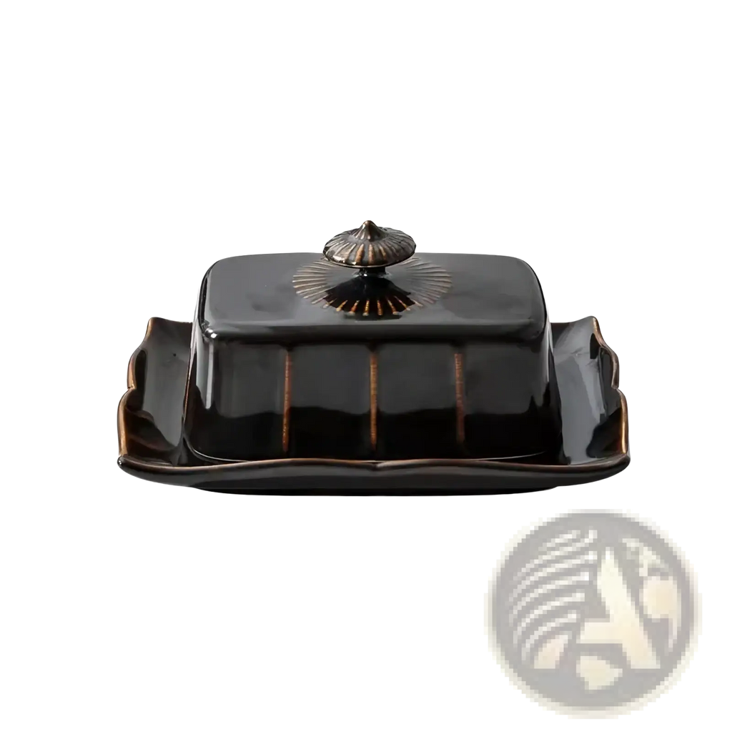Black ceramic butter dish with glossy finish and gold-toned decorative lid for elegant kitchen use