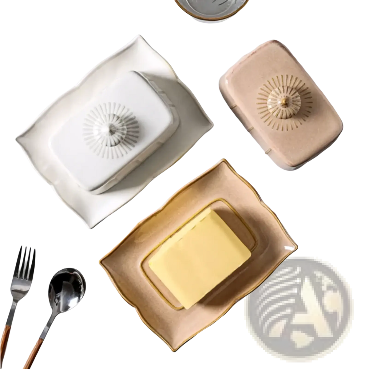Cream-colored ceramic butter dish with gold trim and a sunburst pattern on the lid for elegant butter storage
