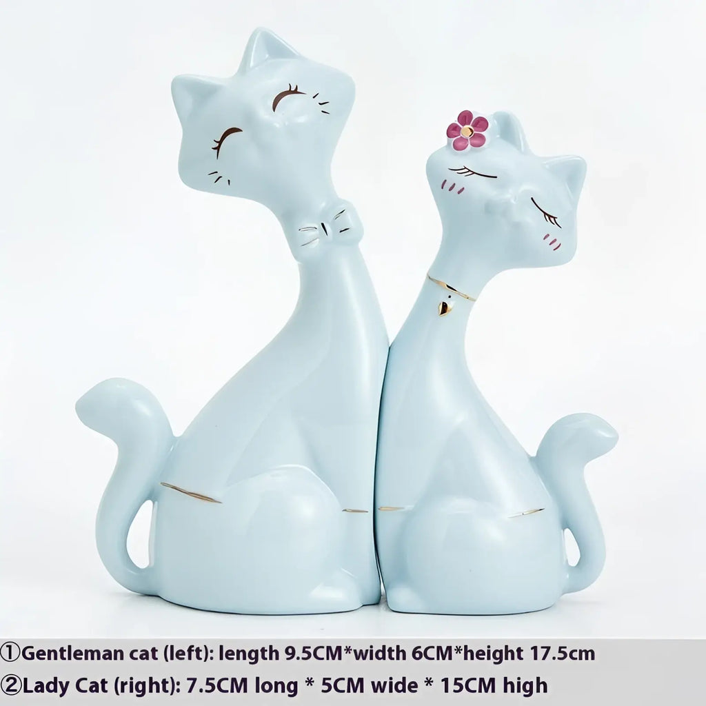 Light blue ceramic cat figurines with modern gold and white accents featuring a bow tie and pink flower decoration