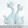 Light blue ceramic cat figurines with modern gold and white accents featuring a bow tie and pink flower decoration