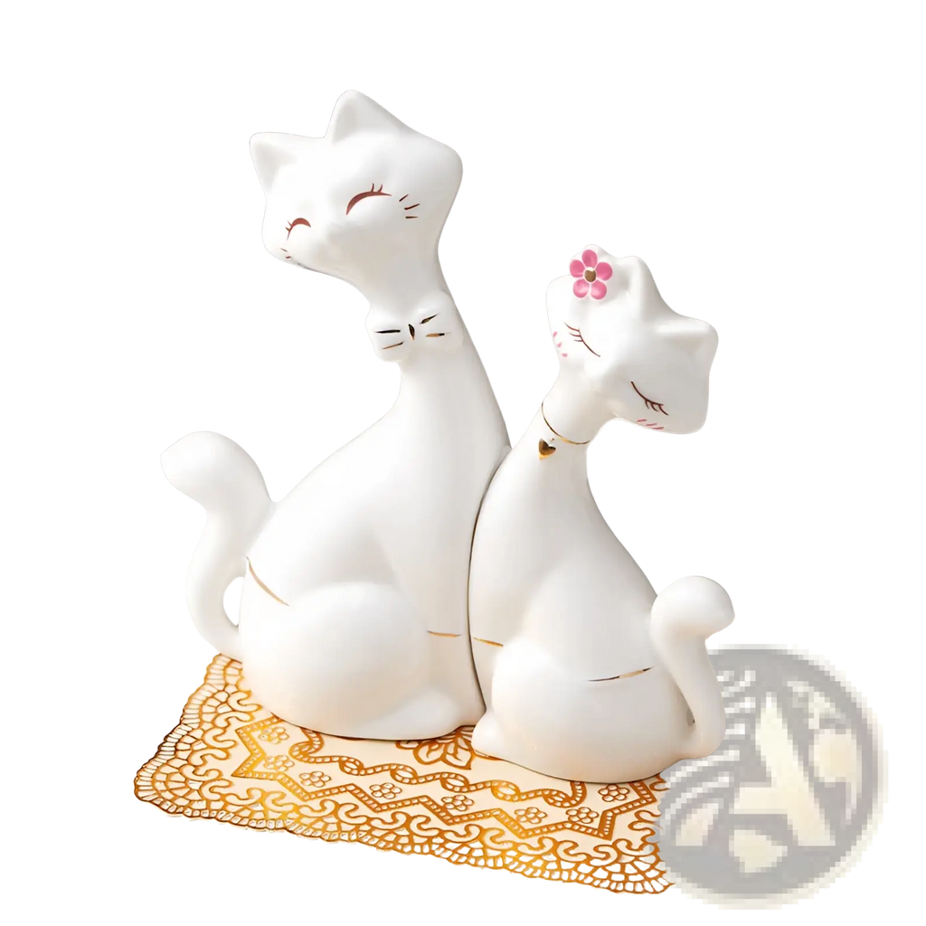 White ceramic cat figurines with gold accents and a pink flower detail modern gold and white home decor piece