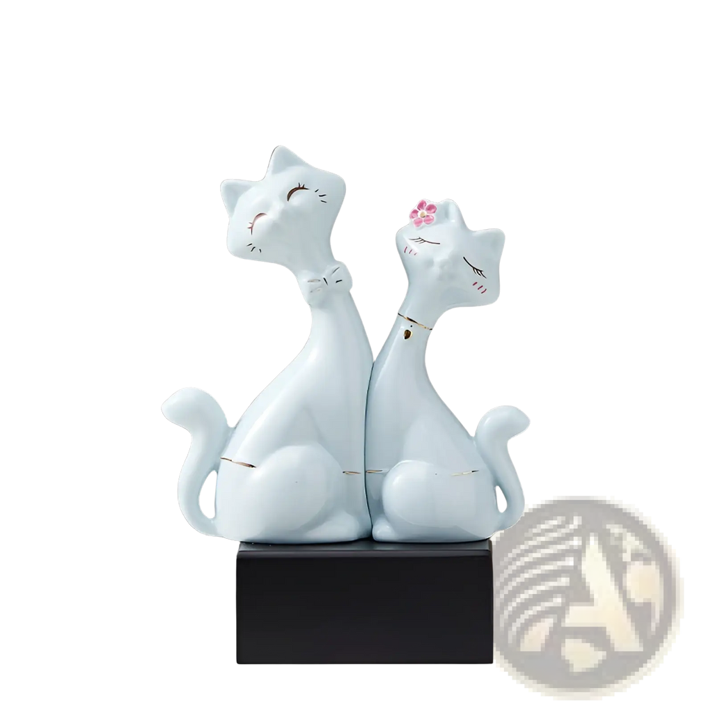 Light blue ceramic figurine of two stylized cats sitting side by side on a black base for modern home decor