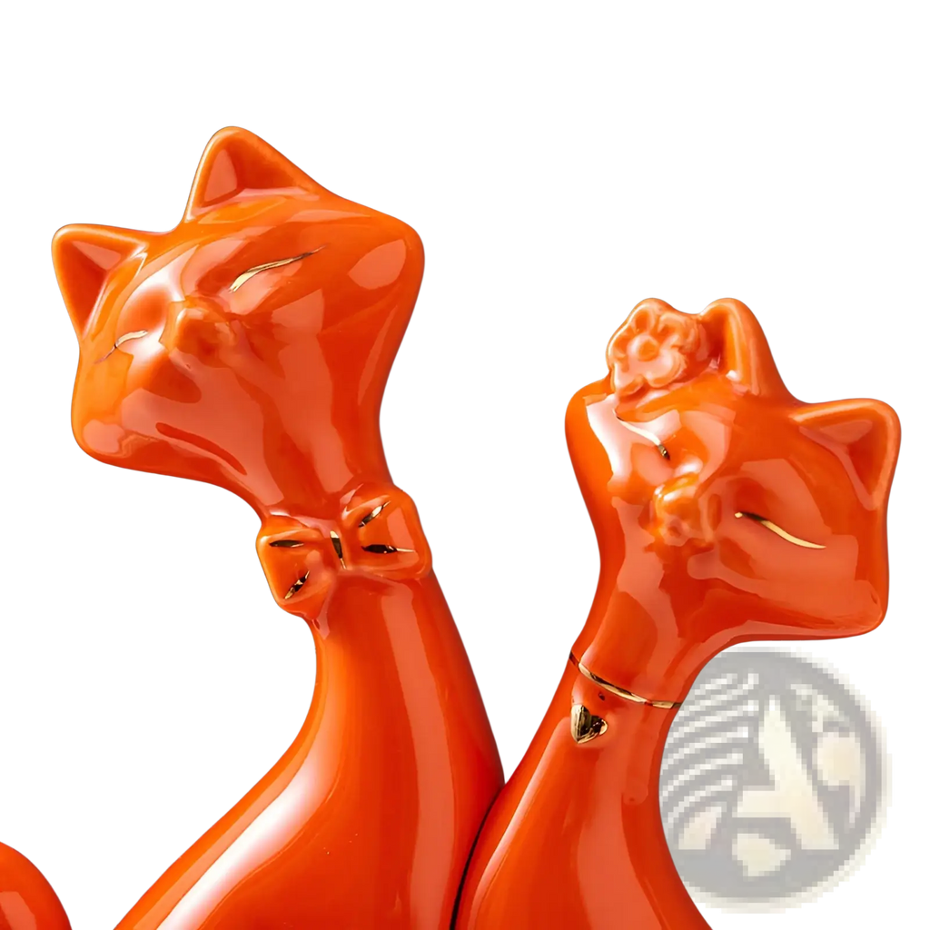 Vibrant orange ceramic cat figurines with glossy finish and gold accents for modern gold and white home decor