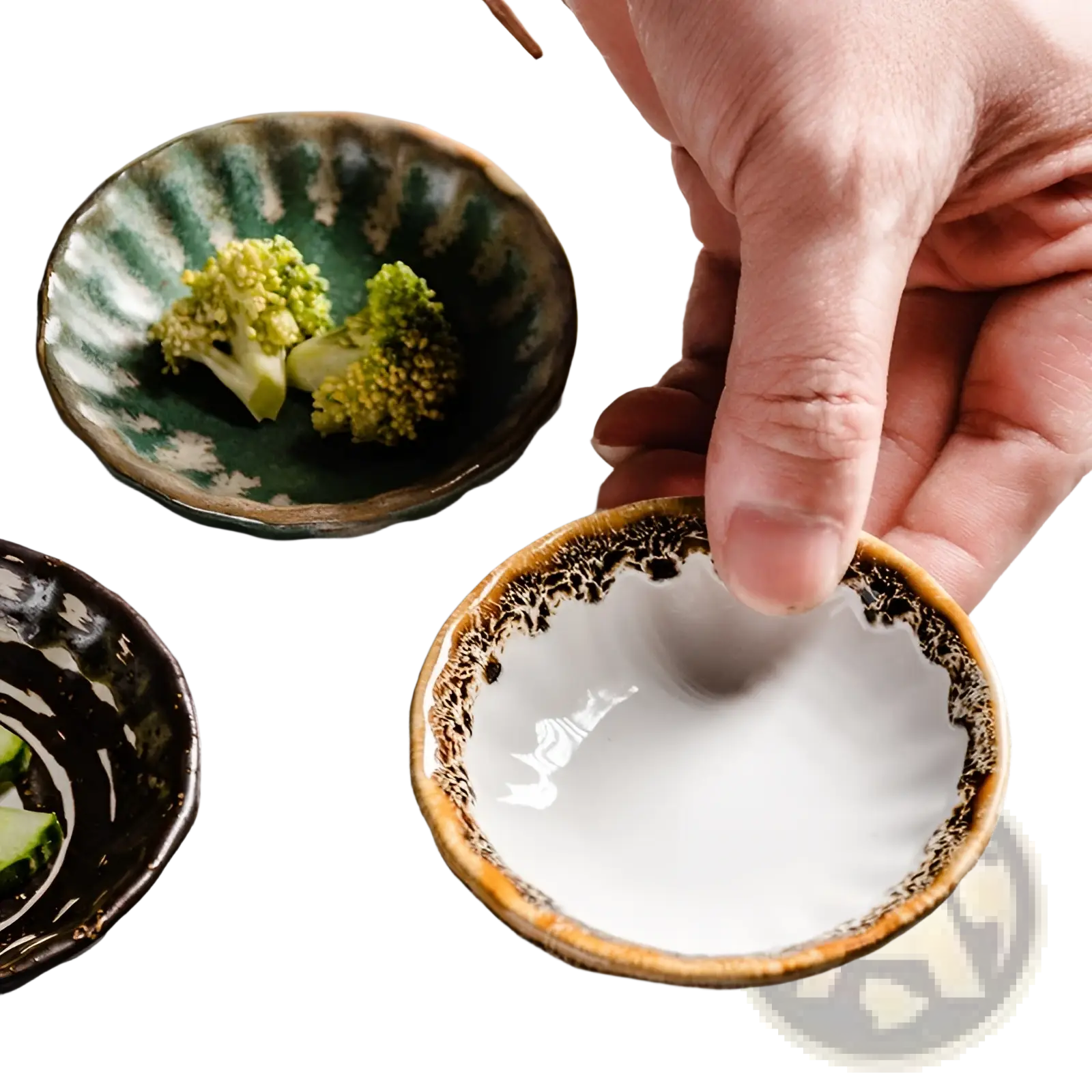 A hand holds a small white ceramic condiment bowl with a speckled brown rim and textured interior for snacks