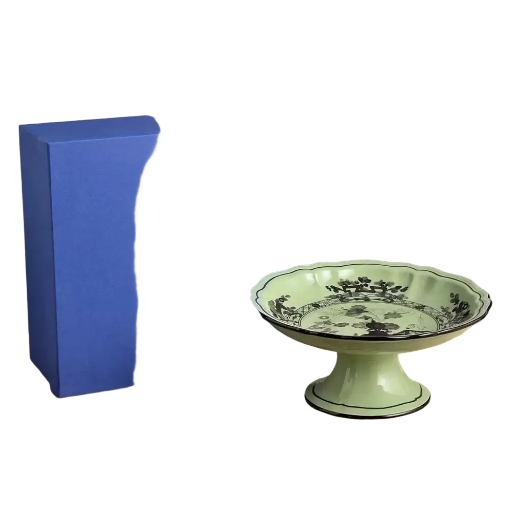 A delicate mint-green ceramic dessert bowl with fluted rim and black floral pattern from a ceramic floral tableware set