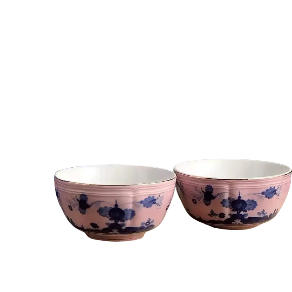 Pink ceramic tea bowls with blue floral and bird motifs and gold-rimmed edges from ceramic floral tableware set